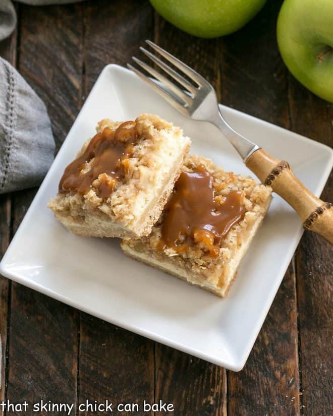 Caramel Apple Bars on a square white plate with a bamboo handled fork