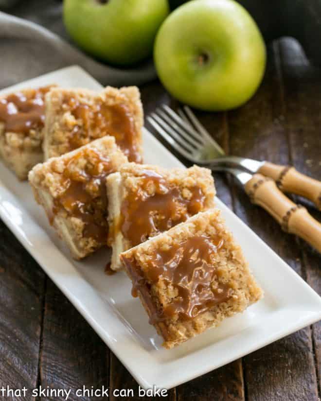 Caramel Apple Bars on a white ceramic plate with 2 forks