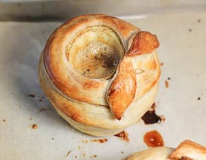 Pastry Wrapped Caramel Apples on a parchment lined baking sheet