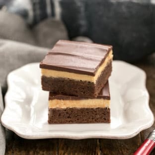 Stack of Peanut Butter Truffle Brownies on a white dessert plate