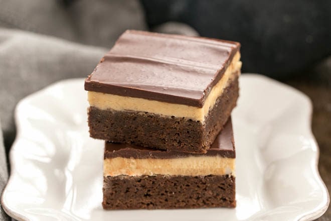 Stack of Peanut Butter Truffle Brownies on a white dessert plate