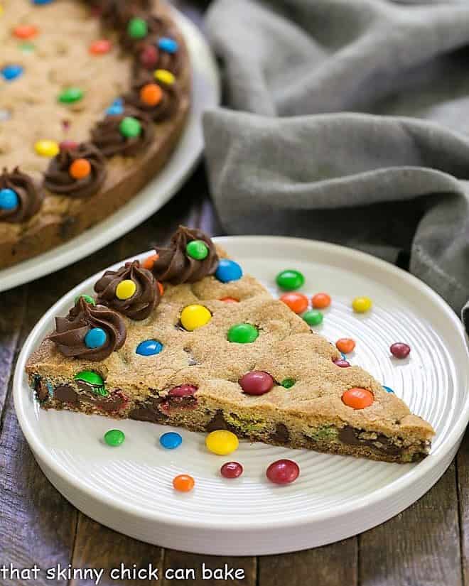 Wedge of chocolate chip cookie cake on a white plate