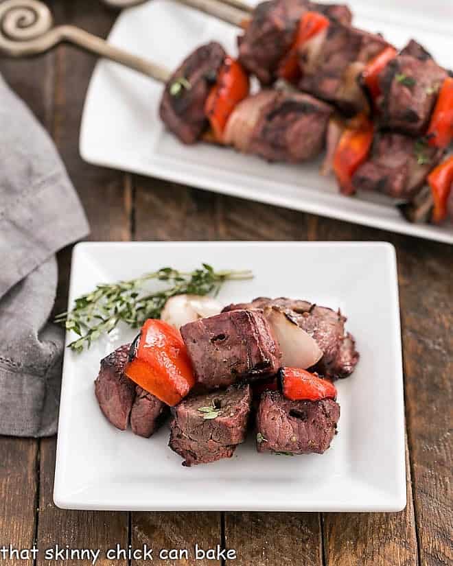 Marinated Greek Lamb Kebabs taken off the skewers on a square white plate.