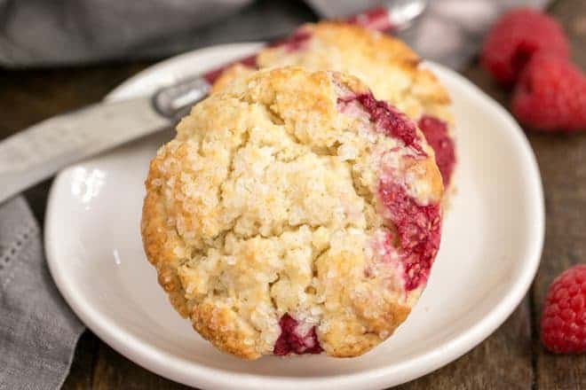 Raspberry Cream Scones on a white plate with a red handled knife
