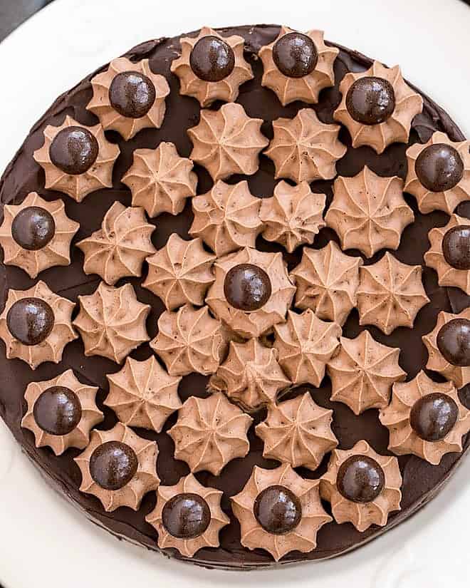 Overhead view of Death By Chocolate Cake on a white cake plate.