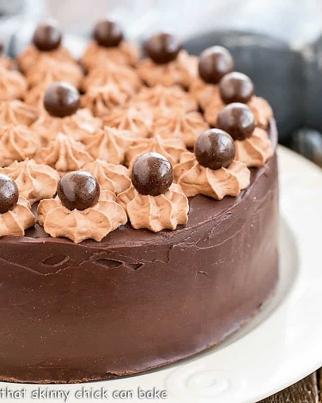 Death By Chocolate Cake topped with mousse stars and malted milk bars.
