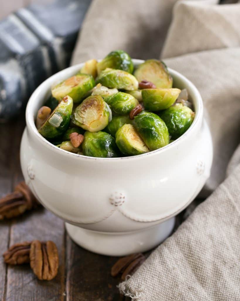 A white bowl of Brussels sprouts