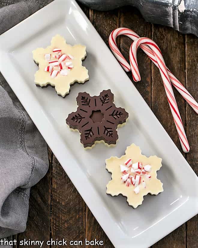 Overhead view of front and back of layered peppermint bark snowflakes.