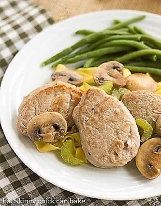 Easy Pork Scaloppine on a white plate with green beans