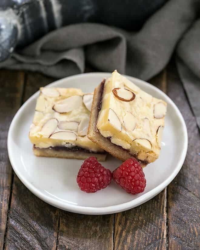 Raspberry Filled White Chocolate Bar on a round white plate with 2 raspberries