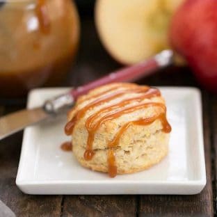 One Caramel Apple Scone on a square white platae with a red handled knife