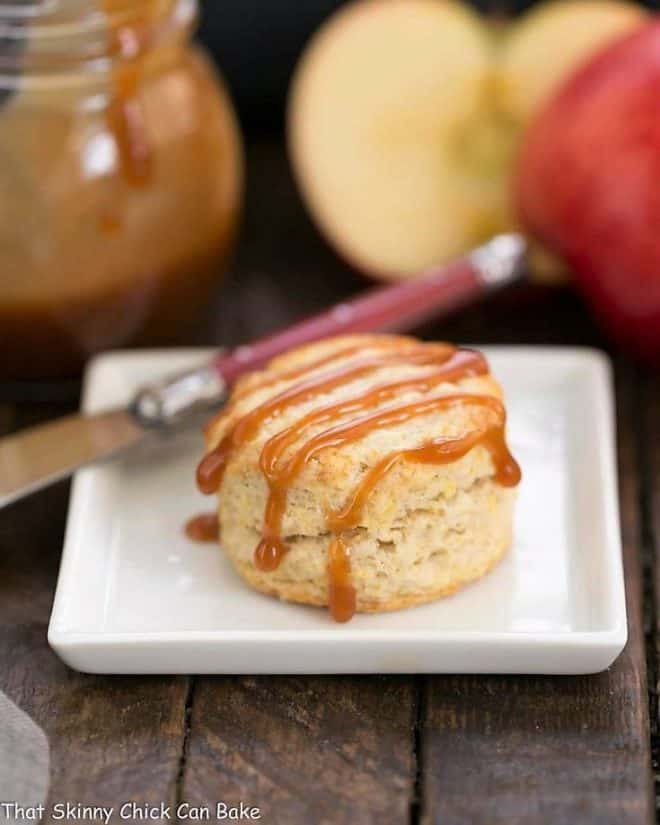 One Caramel Apple Scone on a square white platae with a red handled knife