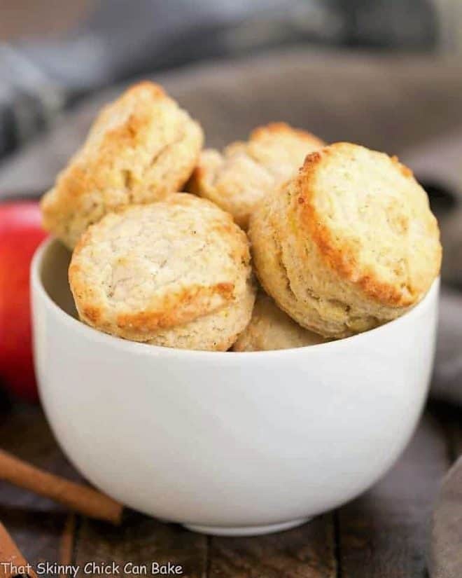 A white ceramic bowl filled with round Caramel Apple Scones 