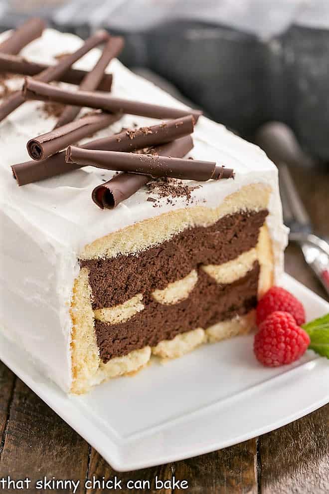 Chocolate Mousse Cake with slice removed, topped with chocolate curls