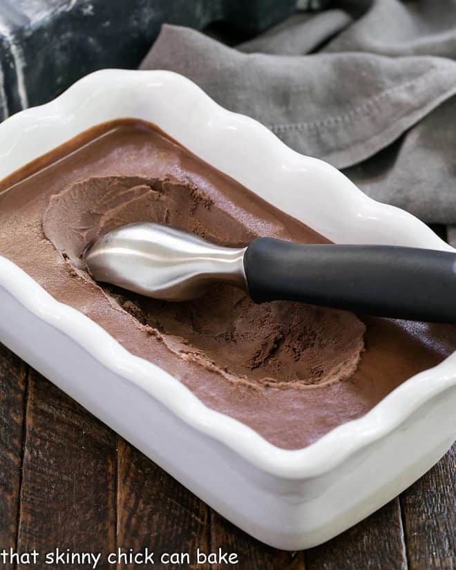 Chocolate Velvet Ice cream in a white ceramic terrine with an ice cream scoop