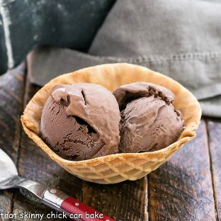Chocolate ice cream scoops in a waffle cone bowl