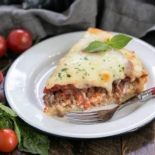 Spaghetti pie slice on a white plate.