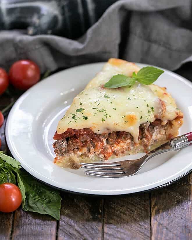 Spaghetti pie slice on a white plate.