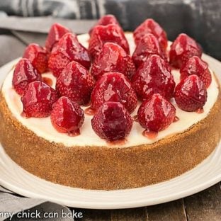 Strawberry Topped Cheesecake on a white ceramic serving plate