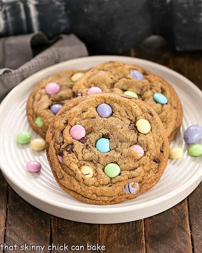 3 Brown Butter Easter Cookies on a rimmed white place surrounded by pastel M&M's