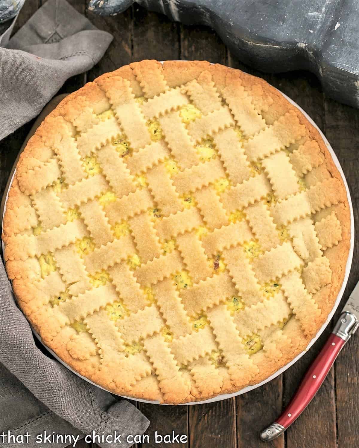 Overhead view of Pizza Rustica next to a red handled knife.