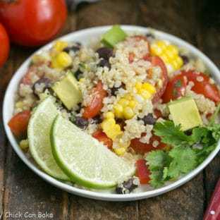 Quinoa Salad in a white bowl with a lime garnish