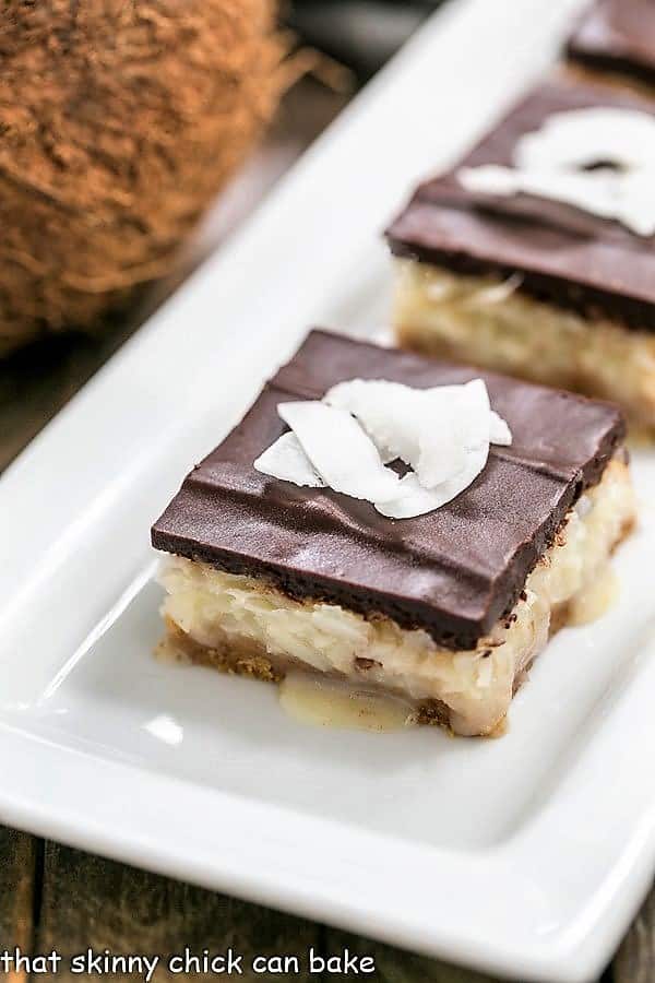 Homemade Coconut Bars on a white ceramic tray.