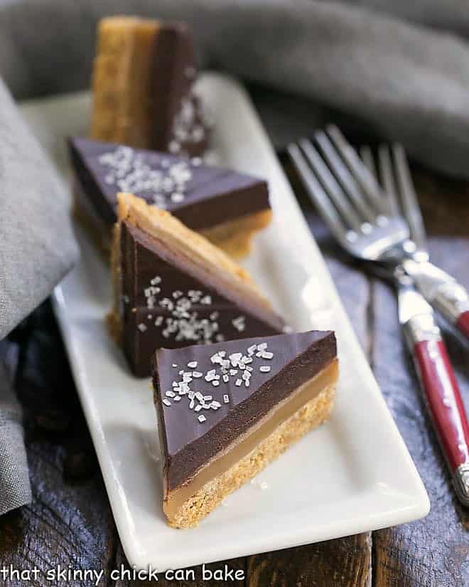 Wedges of Caramel Espresso Bars on a rectangular white ceramic tray.