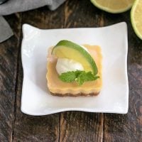 Key lime tartlet topped with cream and a half lime slice