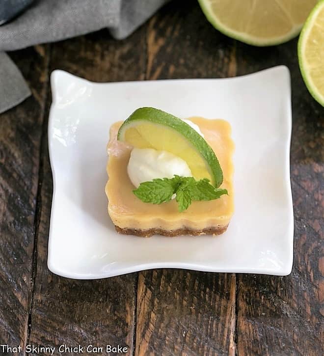 Key lime tartlet topped with cream and a half lime slice