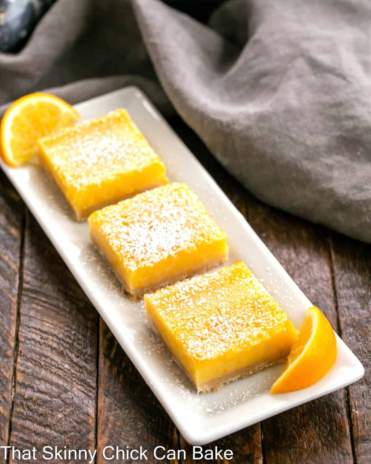 A white ceramic tray with 3 Meyer Lemon Bars.