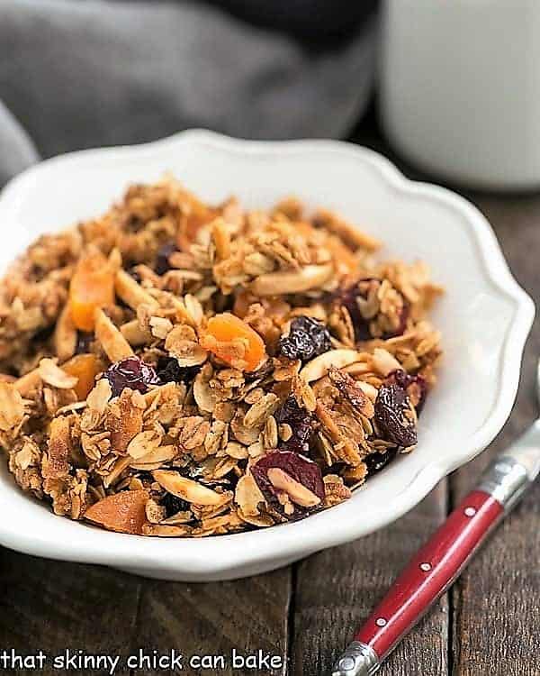 Vanilla Granola with Dried Fruit and vanilla in a white scalloped cereal bowl