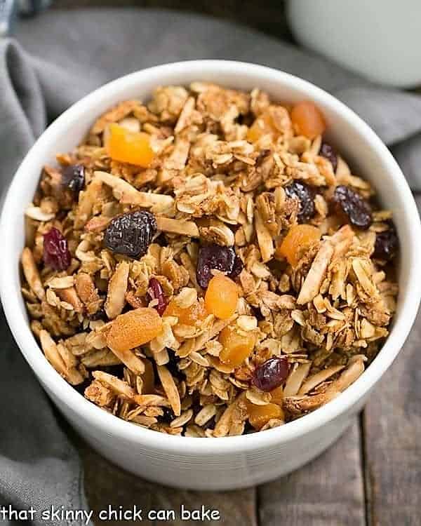 Overhead view of vanilla granola with dried fruit in a white bowl