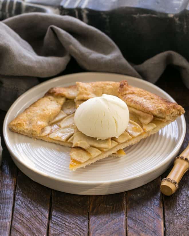 Two slices of Apple Tart on a white plate with a scoop of ice cream