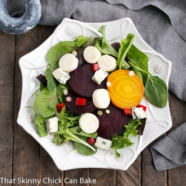 Beet Salad with Blue Cheese and Hearts of Palm on a six sided white salad plate.