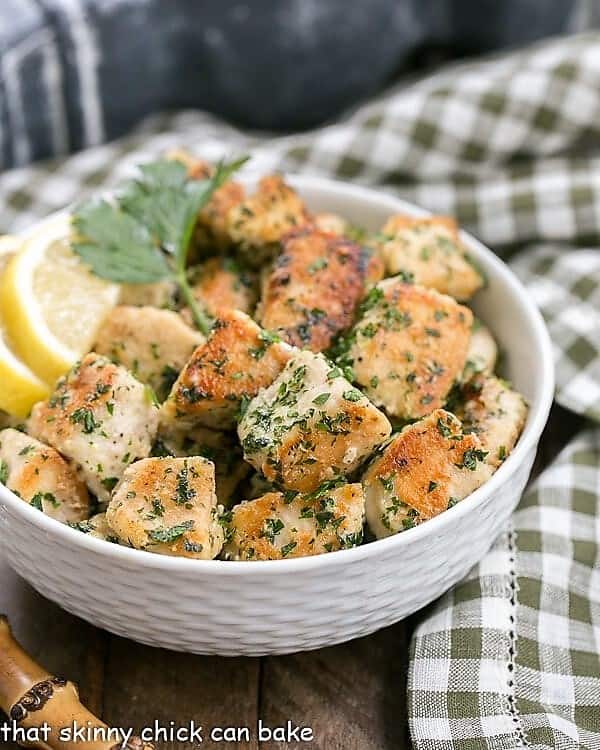 Chicken with Garlic and Parsley in a white bowl with a green and white checked napkin