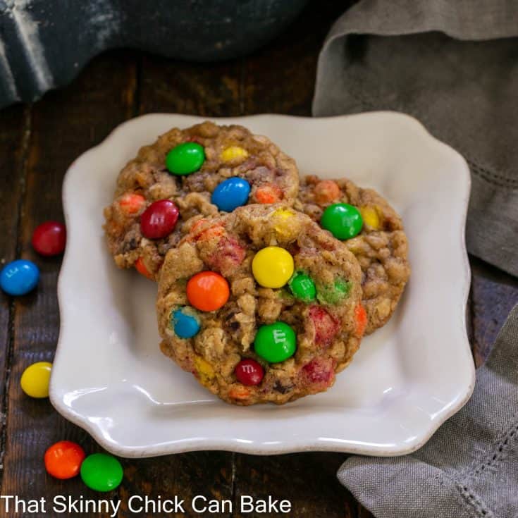 3 oatmeal M & M cookies on a square dessert plate