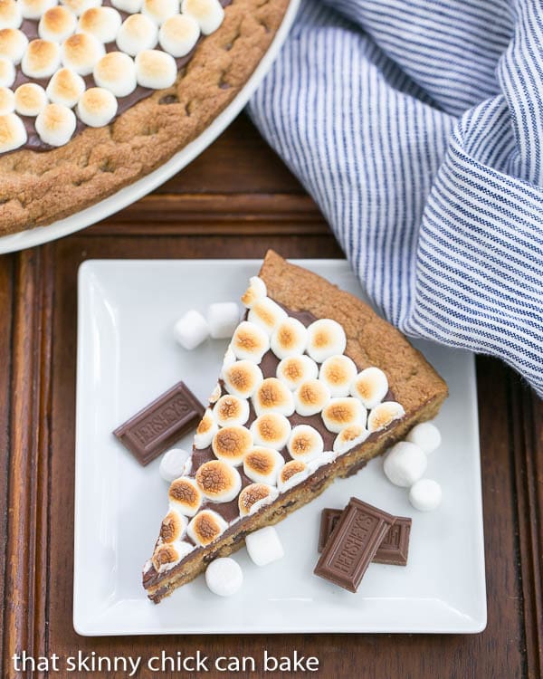 Overhead view of a S'mores Cookie Cake wedge on a square white dessert plate.