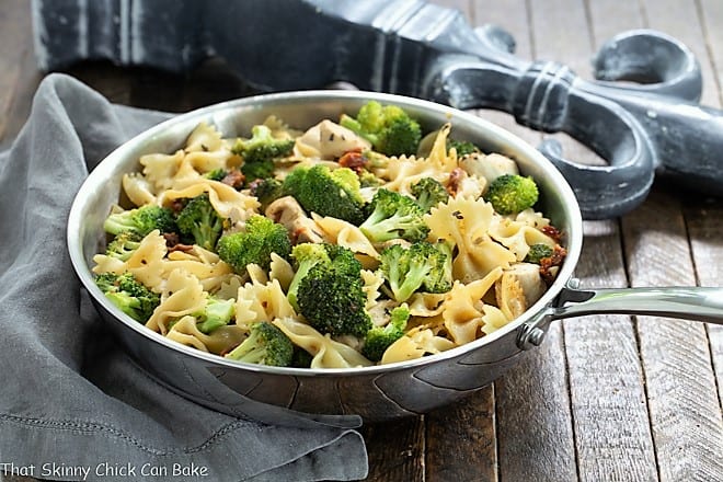 Chicken Broccoli Sun-dried tomato Pasta in a stainless steel frying pan.