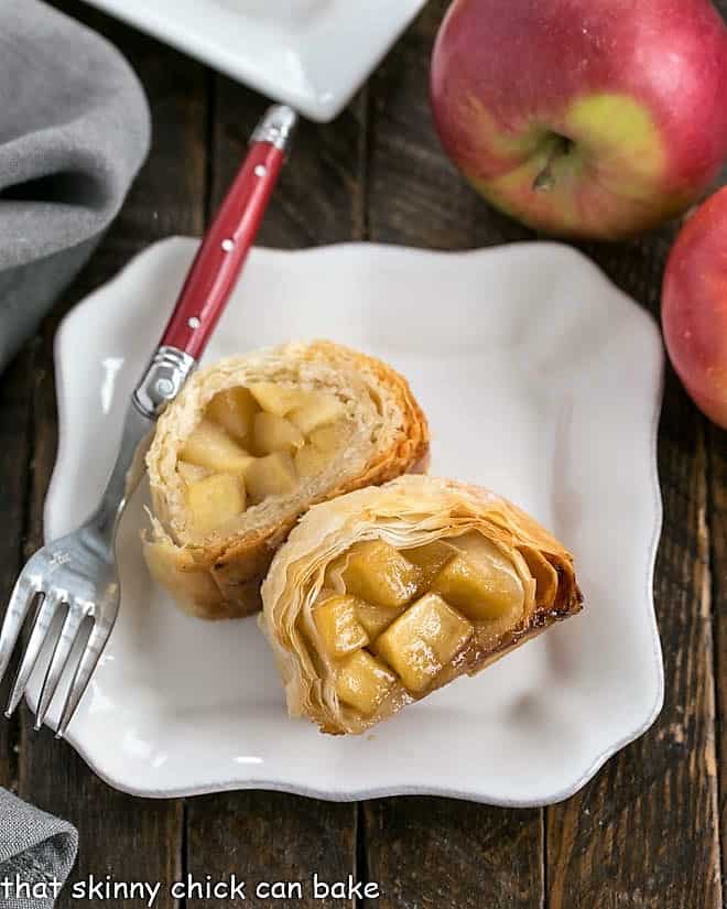 2 slices of apple strudel on a square white plate