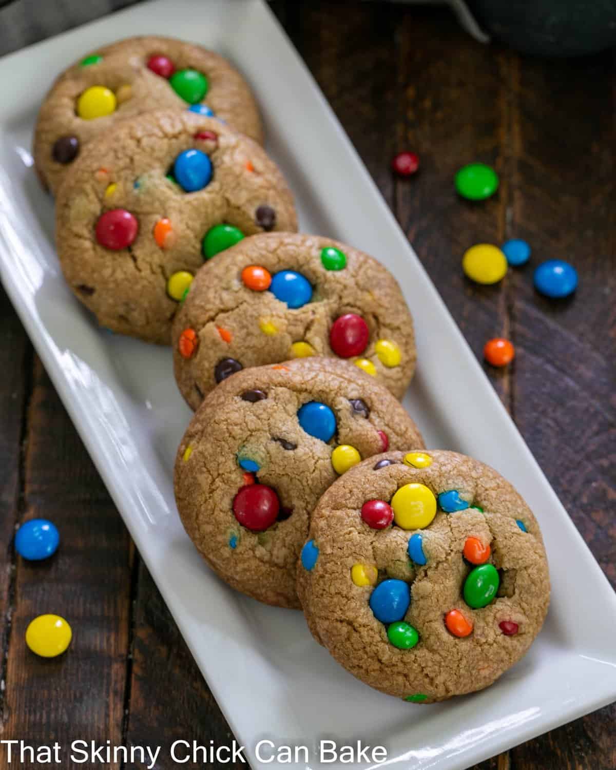 Overhead view of brown butter cookies with M&Ms on a white tray.