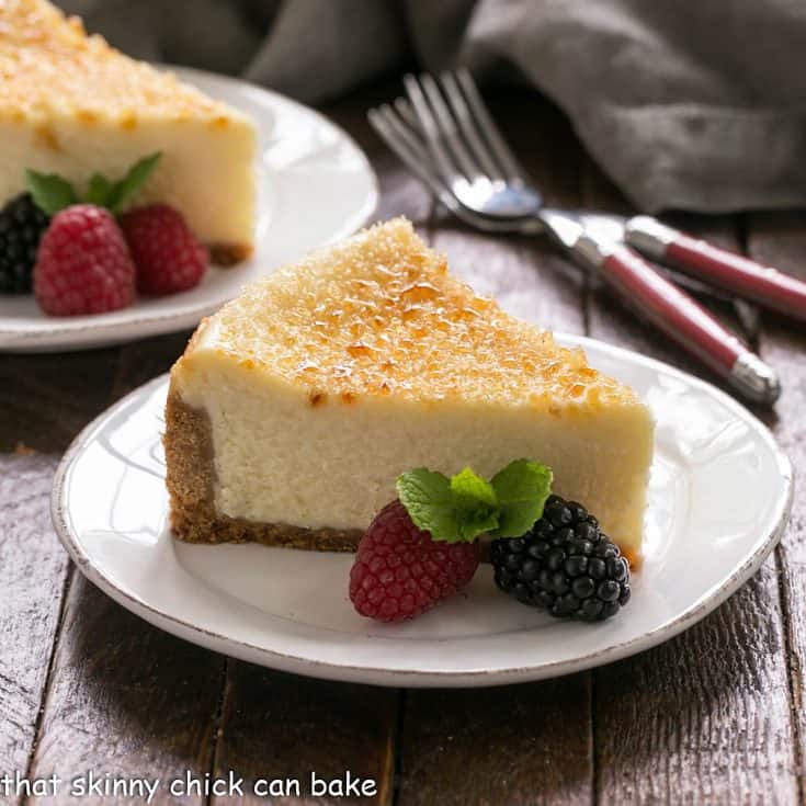 Creme Brulee cheesecake slice on a white dessert plate