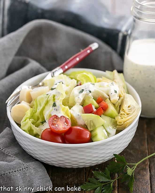 The Ultimate Ranch Dressing in white ceramic bowl with a red handled fork.