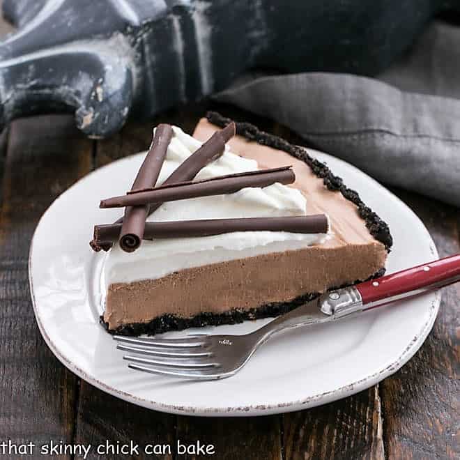 Slice of Candy Bar Pie on a small white plate wit a red handle fork