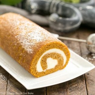 Old Fashioned Pumpkin Roll | With a cream cheese filling on a white tray.