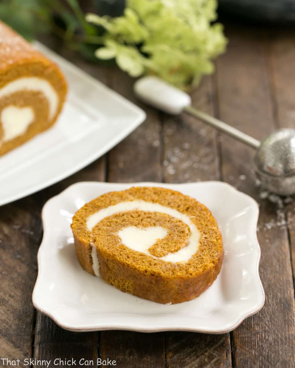 Old Fashioned Pumpkin Roll slice and a square ceramic dish.