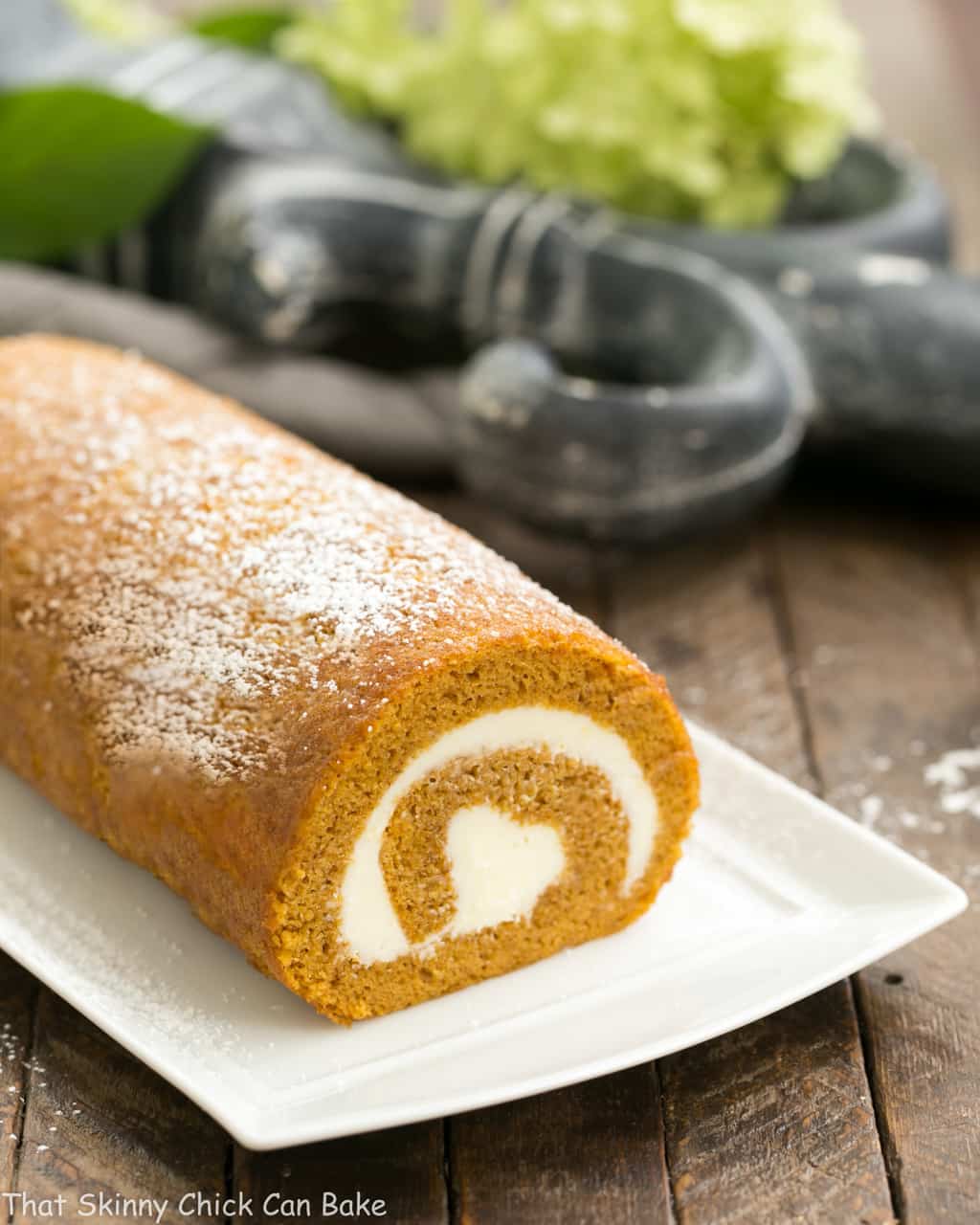 Old fashioned pumpkin roll on a rectangular serving tray.