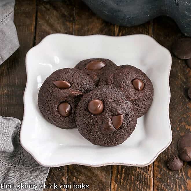 Overhead view of 4 Double Chocolate Cookies on a square white plate