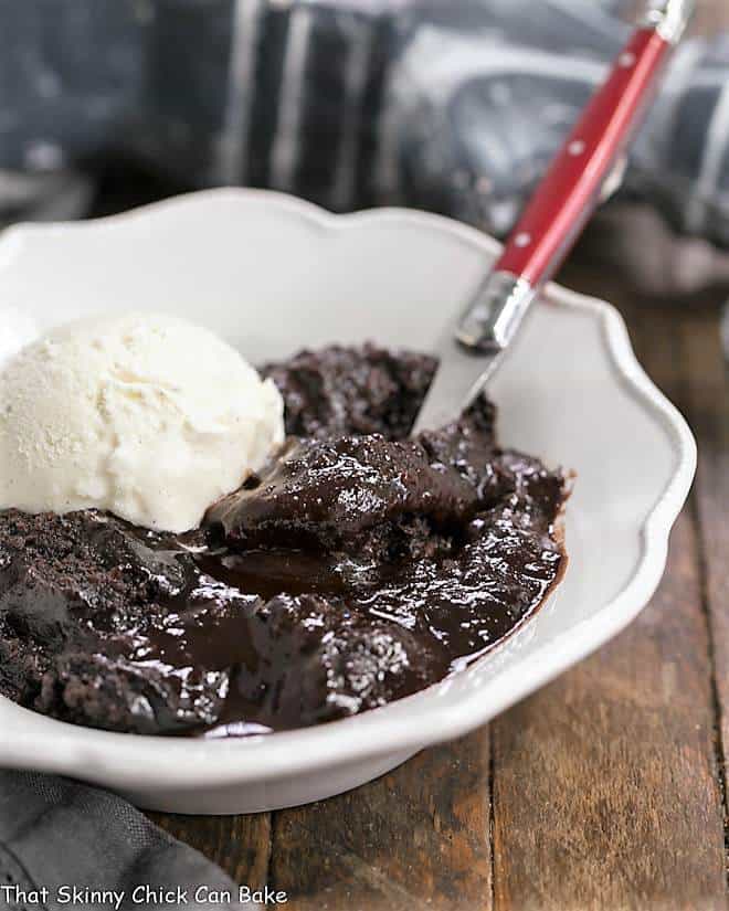 Hot Fudge Pudding Cake in a white bowl with a scoop of ice cream.