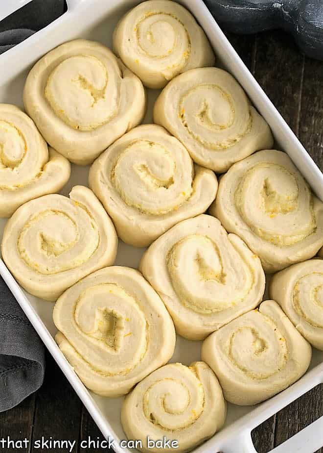 Orange Sweets Rolls - a delicious twist on cinnamon rolls filled and iced with orange zest infused frosting! Sweet Rolls after rising in a 9 x 13 ceramic dish.